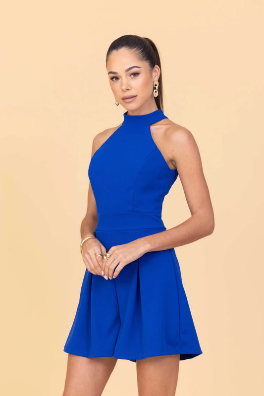 Woman wearing a blue dress against a beige background