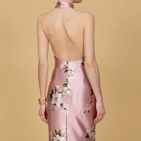 Pink floral dress with open back on a beige background