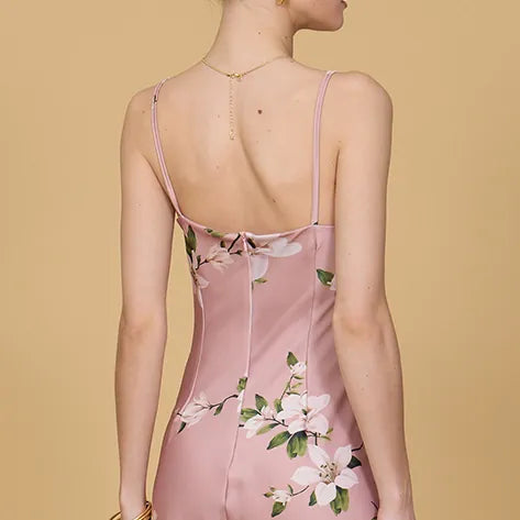 Pink floral dress with thin straps on a beige background