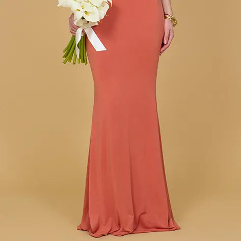 Coral evening gown on a beige background