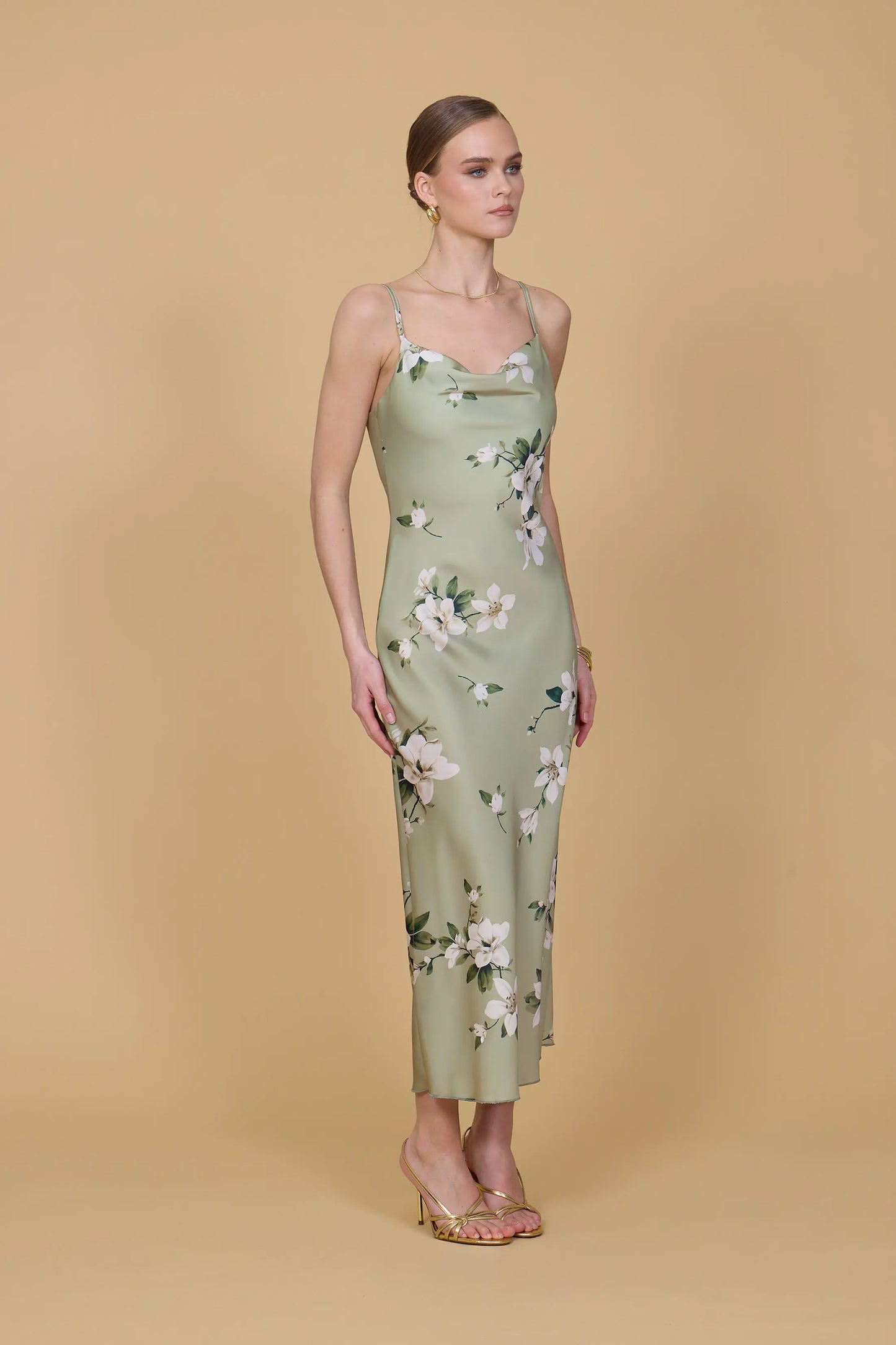 Woman wearing a floral dress against a beige background