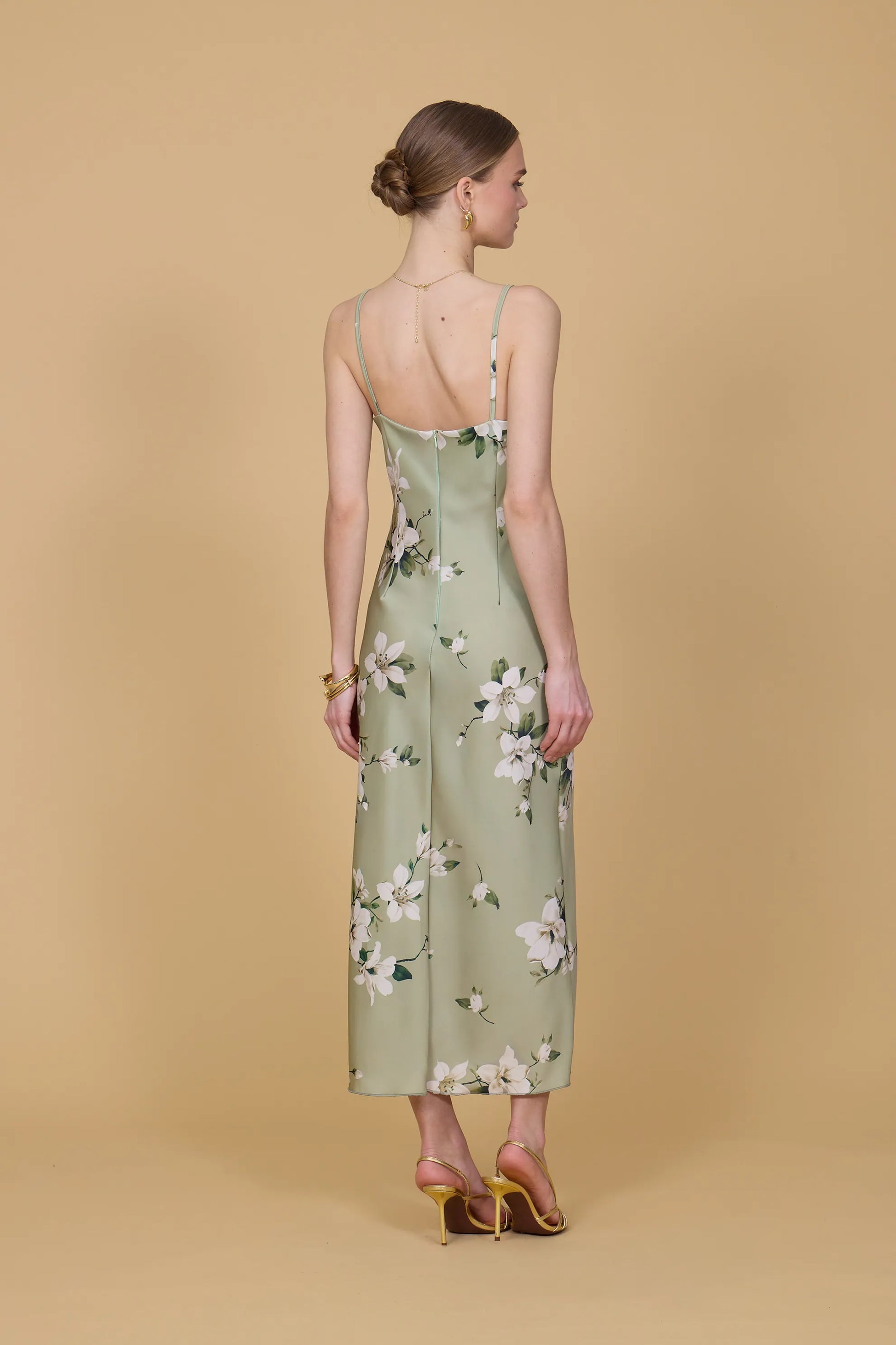 Woman wearing a floral dress on a beige background