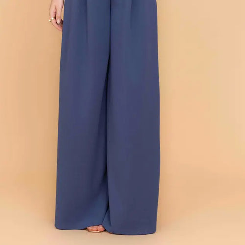 Blue wide-leg pants on a beige background