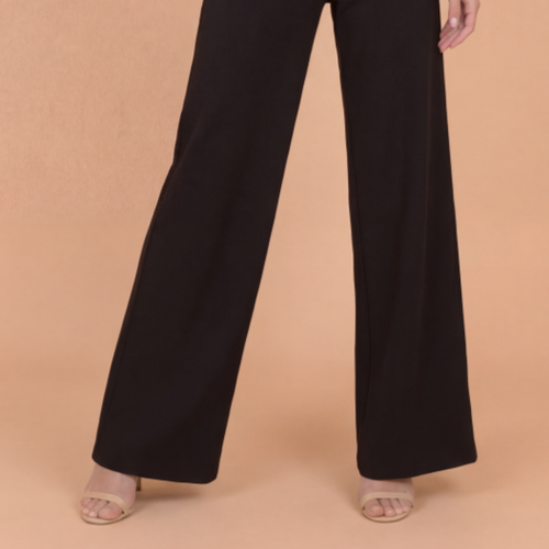 Black wide-leg pants on a beige background