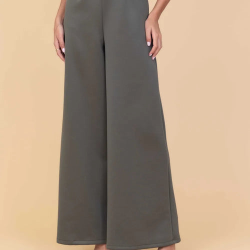 Dark gray wide-leg pants on a beige background