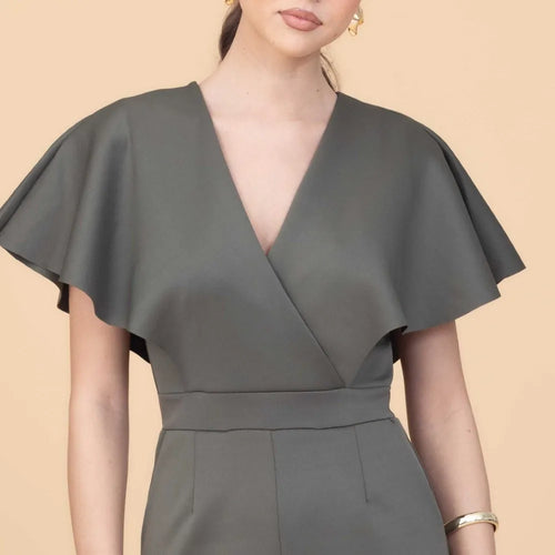 Gray dress with cape detail on a beige background